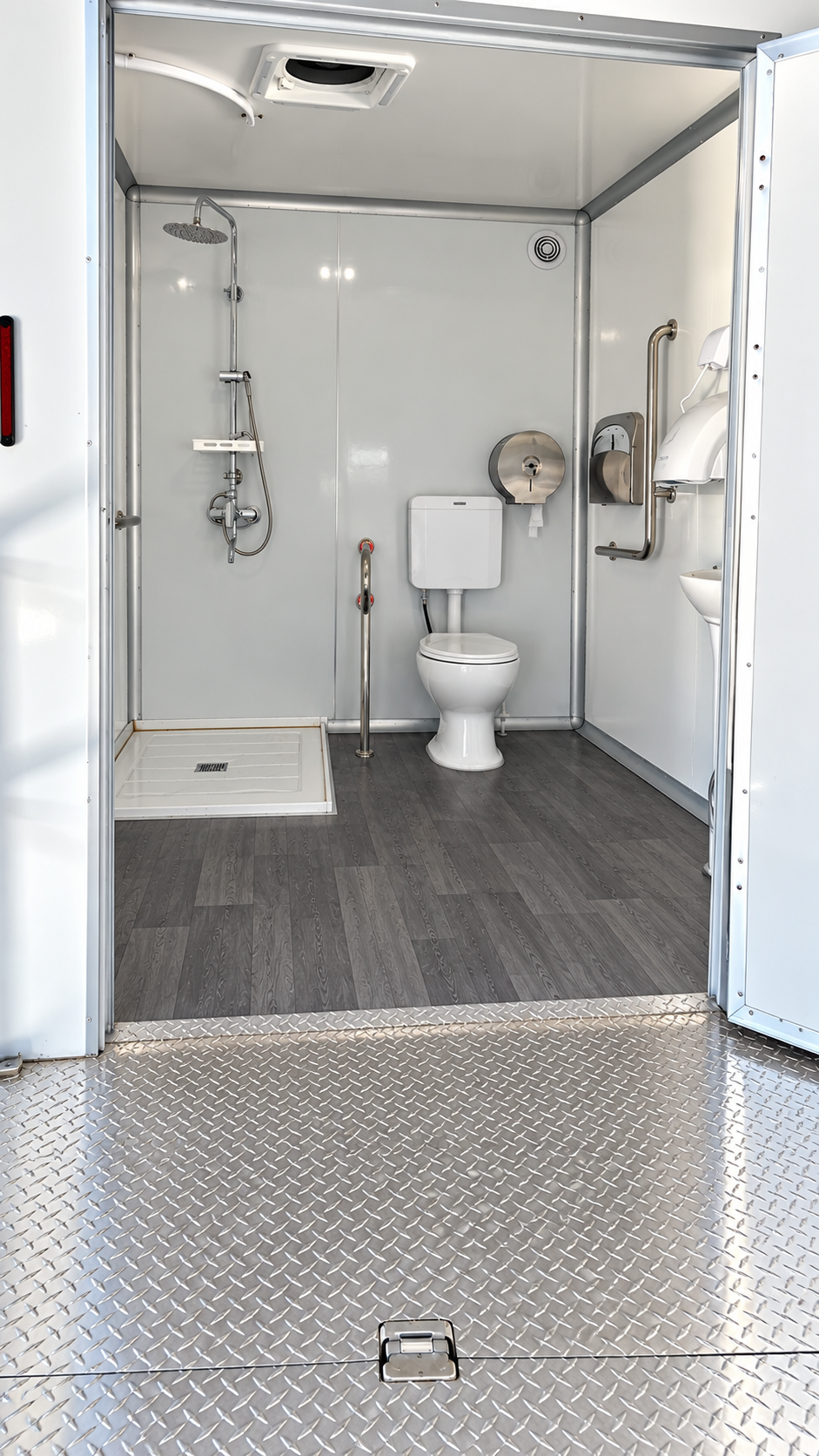 Shower, toilet and sink visible inside a combined facility trailer