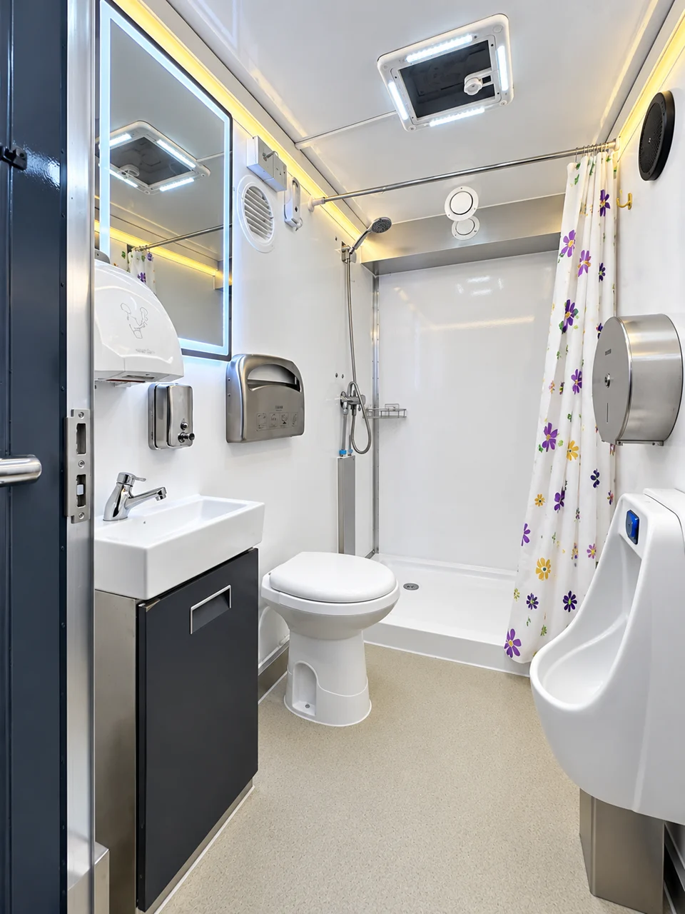Standard shower-restroom trailer room with toilet, sink, urinal and curtained shower