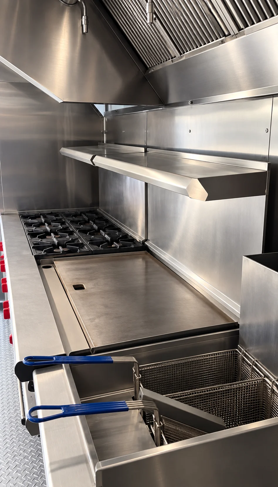 Range, griddle and fryer inside the mobile kitchen