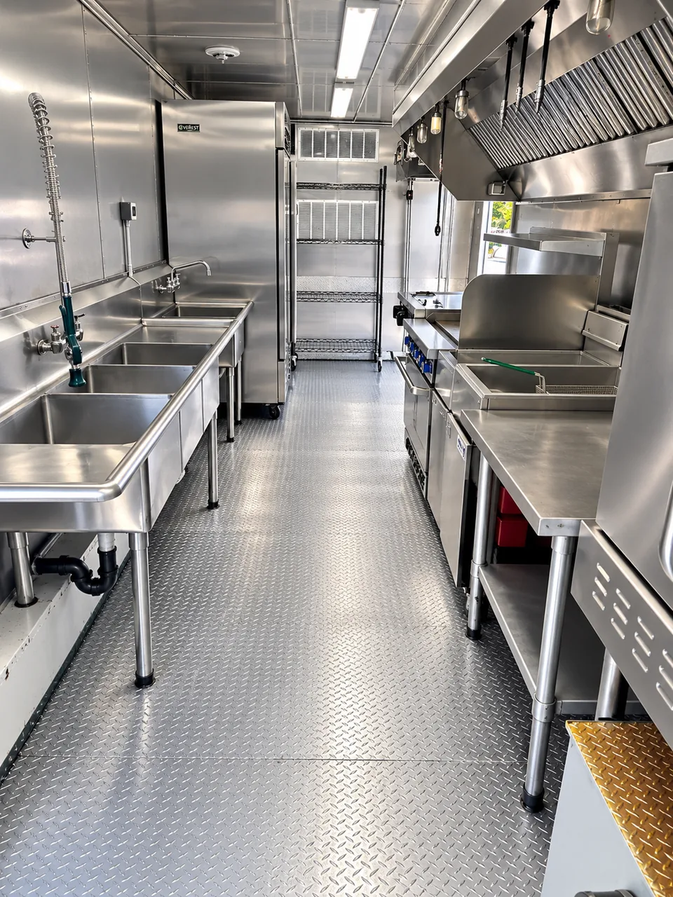 Stainless cooking and preparation aisle in the owner-supplied kitchen reference