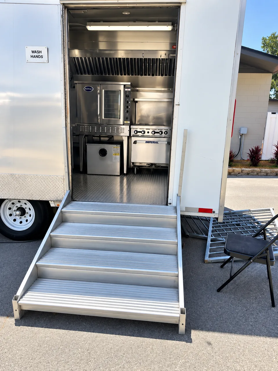 Kitchen trailer entrance with steps and visible cooking equipment