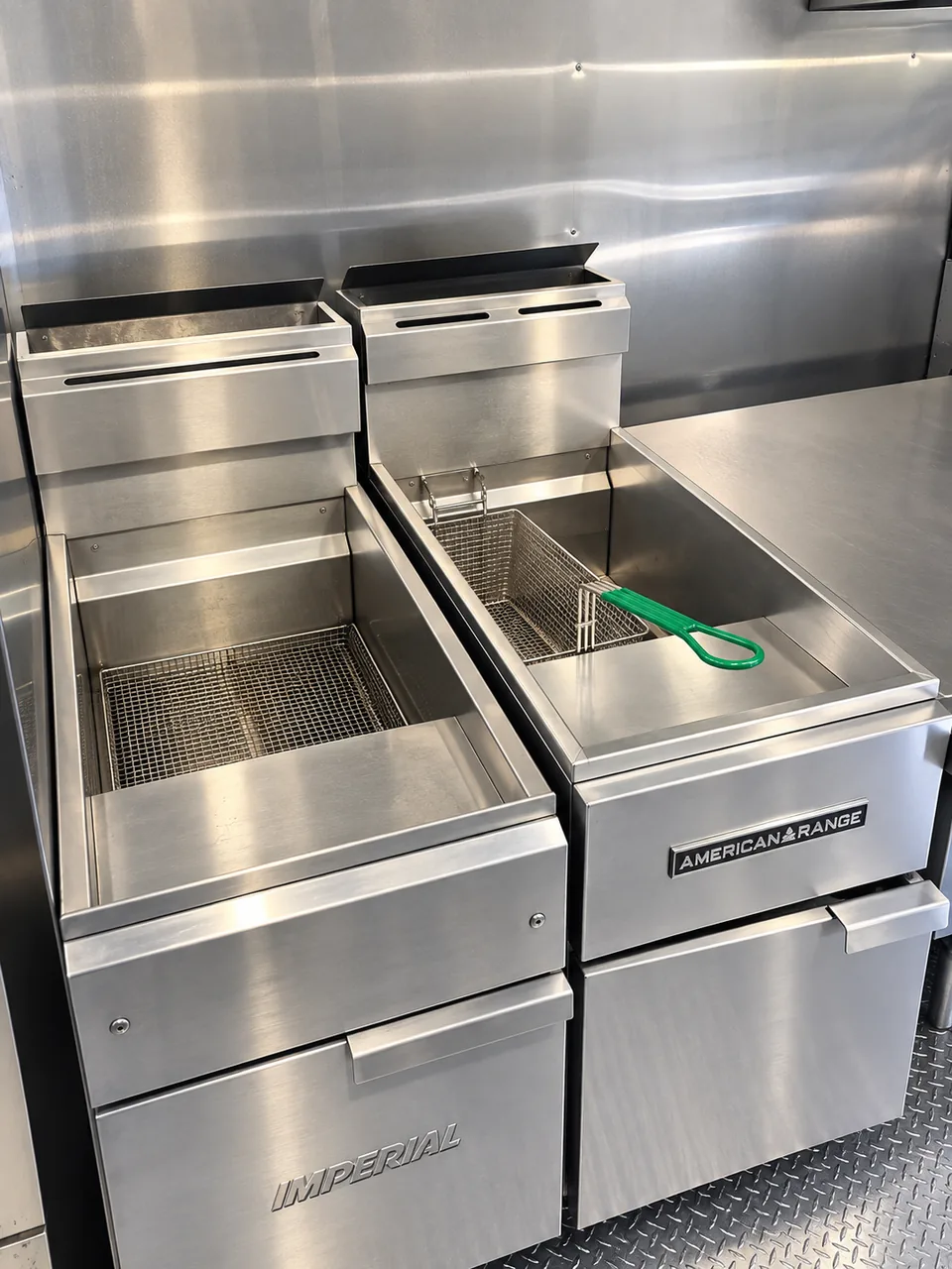 Two commercial fryers in the kitchen trailer