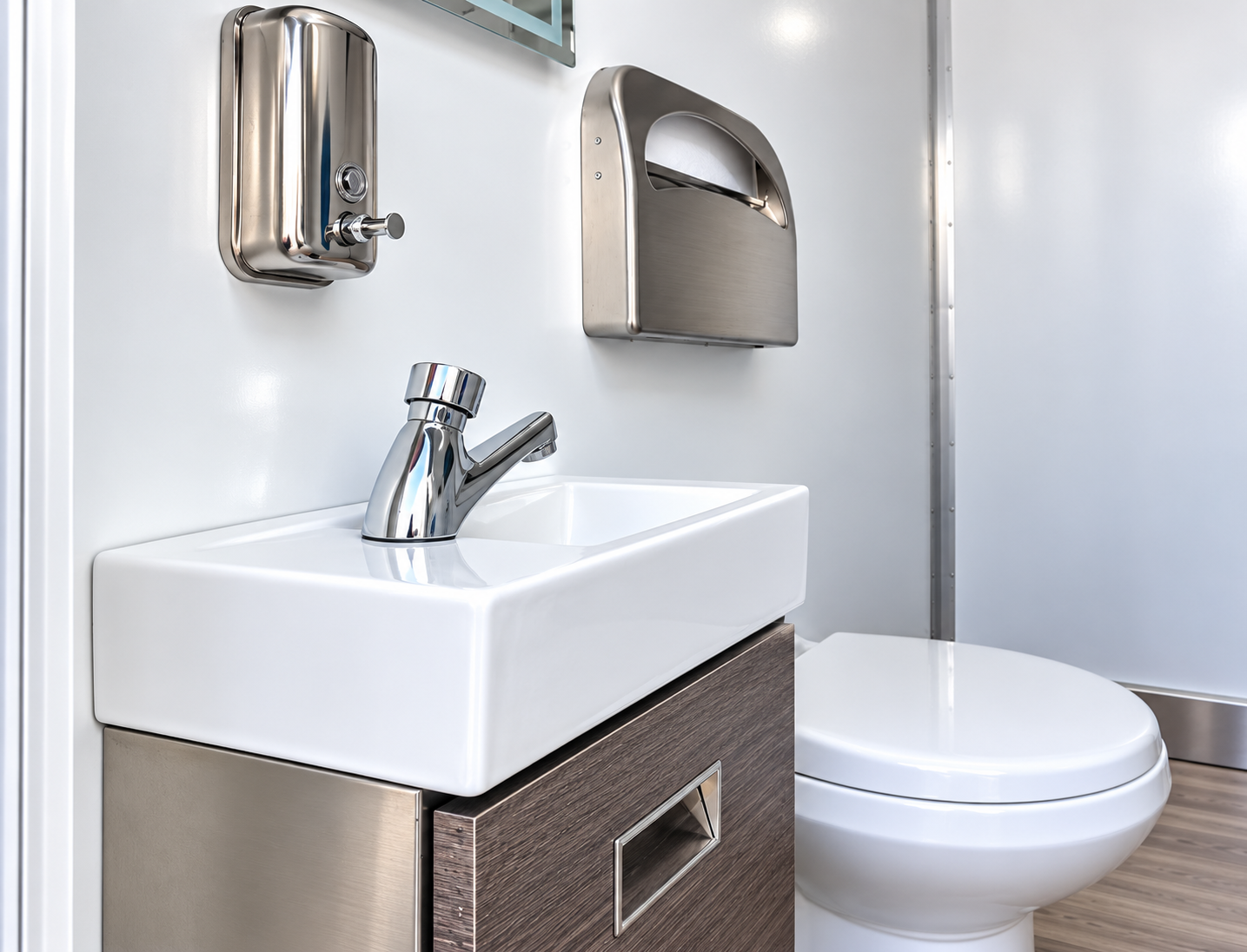 Sink, mirror and toilet in a restroom-only trailer reference